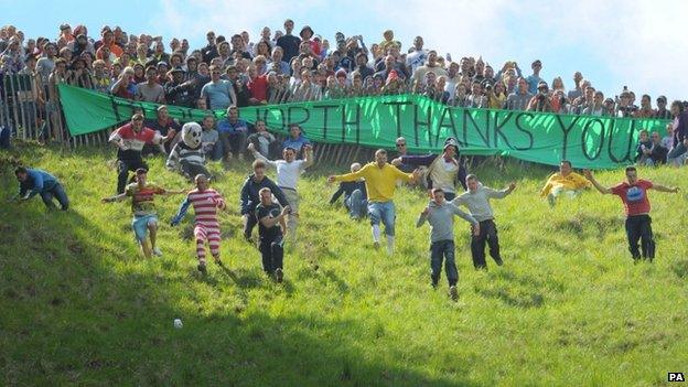 Some 3,000 spectators gathered on Cooper's Hill in the bank holiday sunshine