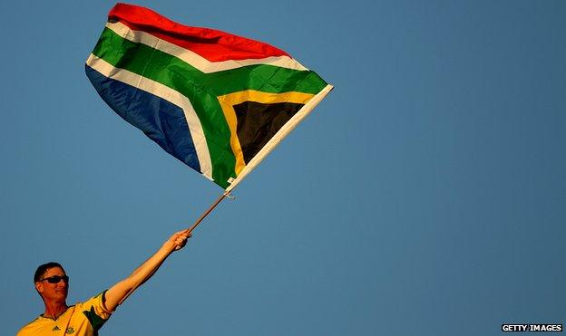 A man waving South Africa's national flag