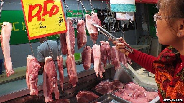 Woman buys Shuanghui supplied pork