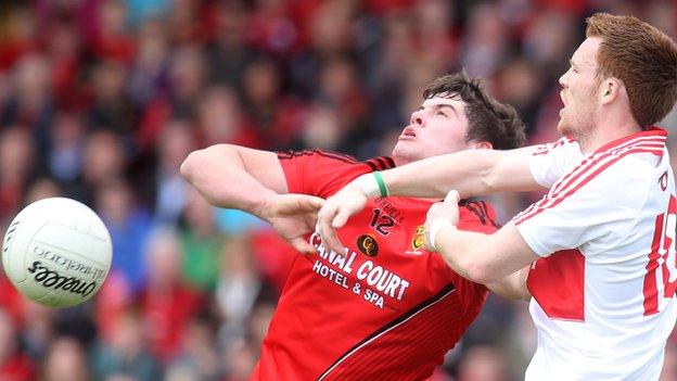 Niall Madine of Down and Derry's Aidan McAlynn