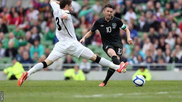 Robbie Keane scores his second goal in the match against Georgia