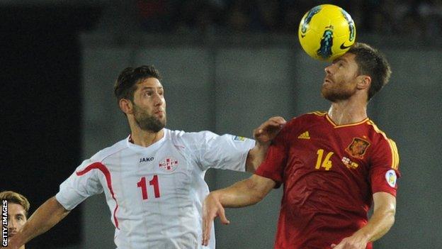 Xabi Alonso wins a header for Spain