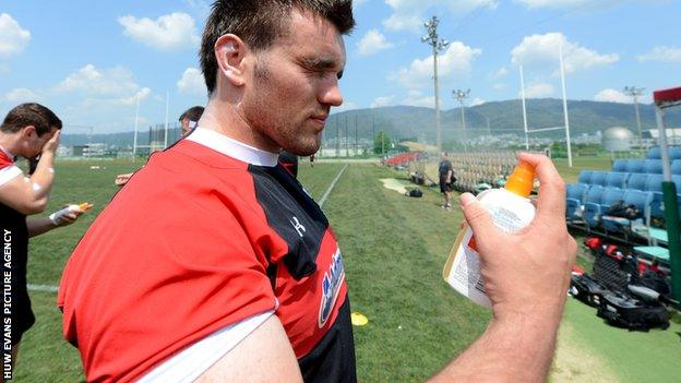 Wales' Emyr Phillips applies sun cream during training