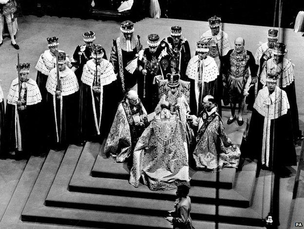 Coronation, with the archbishop kneeling before the Queen