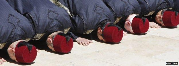 Men in traditional Syrian costume offer prayers in the courtyard of the Umayyad Mosque, in Damascus March 23, 2013