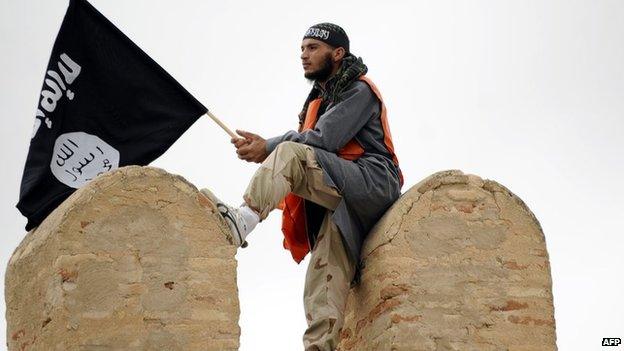 A Tunisian Islamist waves a Salafist flag reading: "There is only one God" during a rally in May 2012 in Tunisia for the Ansar al-Sharia's national congress