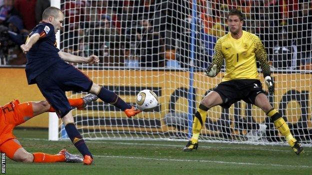 Andres Iniesta (right) shoots to score a goal past goalkeeper Maarten Stekelenburg as Rafael Van Der Vaart tries to block his shot, during their 2010 World Cup final