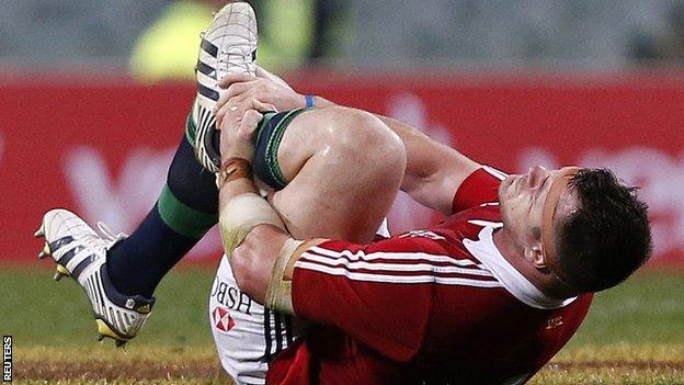 Cian Healy holds his ankle after sustaining his tour-ending injury