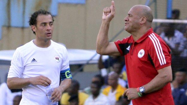 Libya's coach Abdelhafidh Erbish (right) speaks to the team's captain Mohamed El Mughrabi