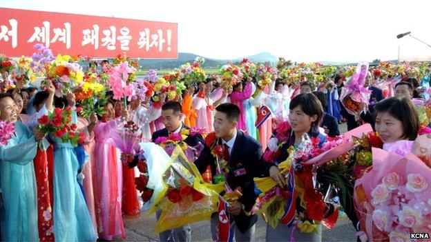 North Korean athletes returning from the Olympics in London last year