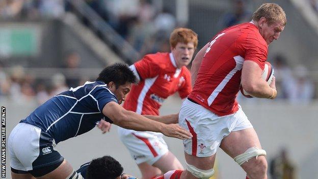 Bradley Davies bursts through a tackle for Wales in Osaka