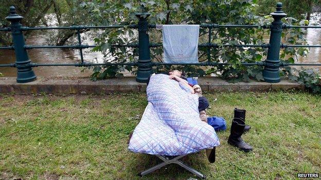 Volunteer rests next to the Elbe at Magdeburg (9 June)