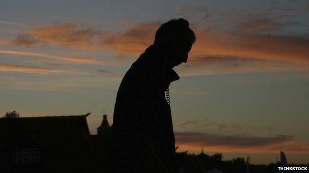 Silhouette of man walking with headphones