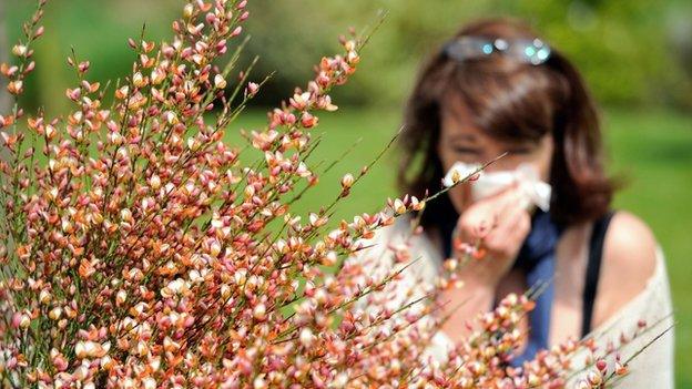 Woman blowing nose