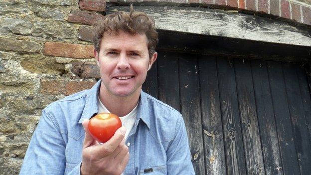 Stefan Gates holding a tomato