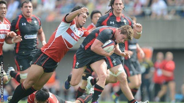 Harry Robinson of Wales is tackled by Hiroshi Yamashita of Japan