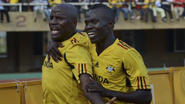 Uganda's Godfrey Massa and Emmanuel Okwi (left)