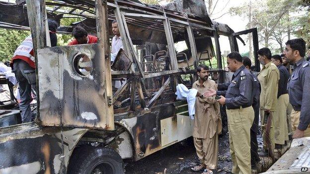 Wreckage of a bus destroyed in a university bomb blast in Quetta, Pakistan, 15 June