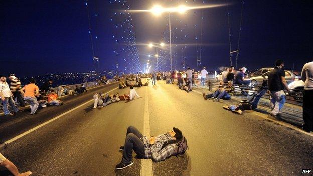 Protesters rest on Istanbul's closed Bosphorous Bridge, early on 16 June