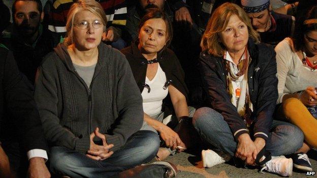 Protesters sit outside the US embassy in Ankara, 16 June