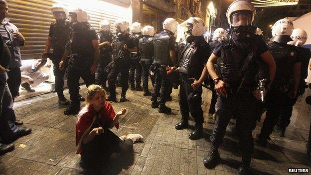 A protester is surrounded by riot police in Istanbul, late on 15 June