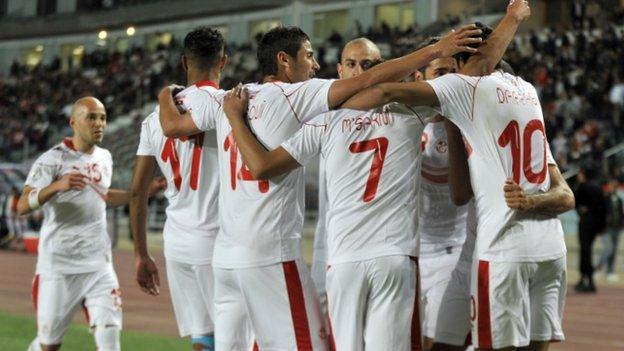 Tunisia players celebrate a goal by Oussama Darragi