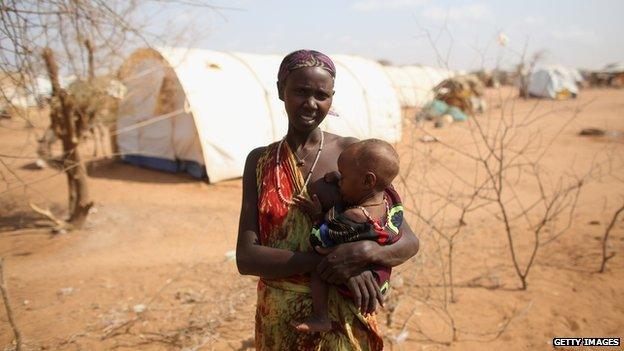 A woman breastfeeding her malnourished child