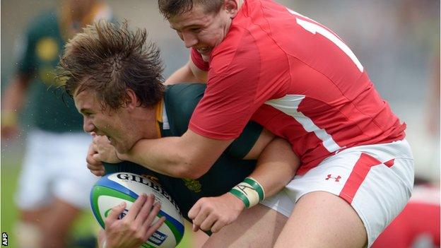 South Africa's Stefan Ungerer is tackled by Wales wing Hallam Amos