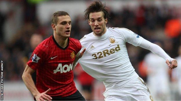 Manchester United's Nemanja Vidic competes with Swansea's Michu for the ball