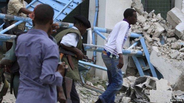 Somali government soldiers pictured after a suicide bomb attack inside the United Nations compound in the Somali capital Mogadishu 19 June 2013