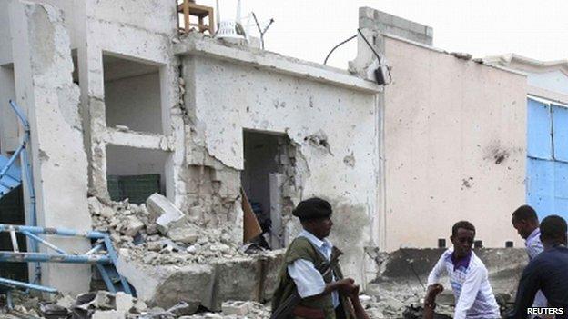 Somali government soldiers evacuate an injured man after a suicide bomb attack inside the United Nations compound in the Somali capital Mogadishu, 19 June 2013