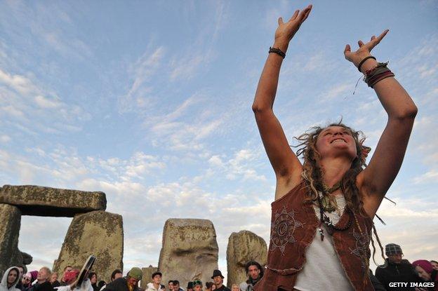 A woman at Stonehenge celebrates summer solstice