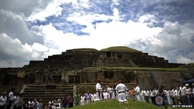 People take part in a Mayan ceremony to celebrate the summer solstice before an ancient Mayan temple