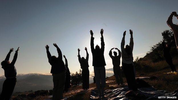 People are practicing yoga at the megalithic observatory of Kokino, in Macedonia