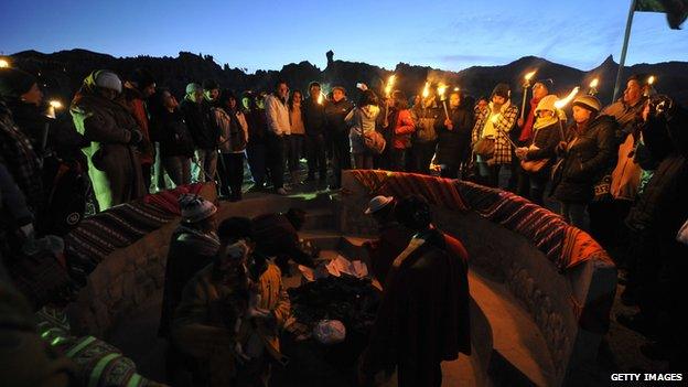 Aymara natives gather at sunrise to celebrate the winter solstice, which marks the Aymara New Year, at the Valley of the Moon, near La Paz, on June 21, 2012.