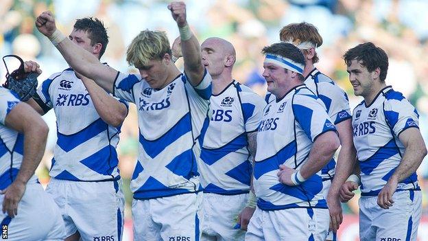 Exhausted Scotland players celebrate their 30-29 win over Italy