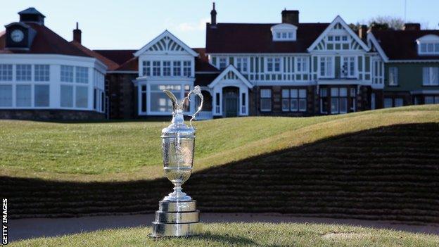 The Claret Jug trophy beside the 18th green in front of the clubhouse at Muirfield