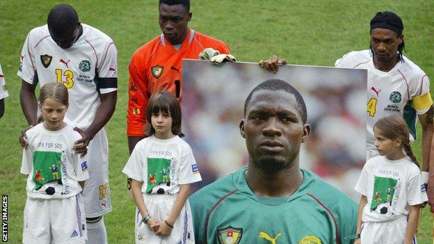 Cameroon players hold a picture of Marc-Vivien Foe