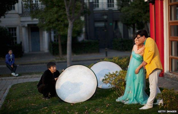 A couple posing for photos in Thames Town, China