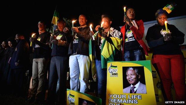 ANC supporters hold a candlelit vigil outside the former home of former South African President Nelson Mandela in Soweto township on June 27, 2013