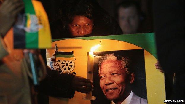 ANC supporters hold a candlelit vigil outside the former home of former South African President Nelson Mandela in Soweto township on June 27, 2013