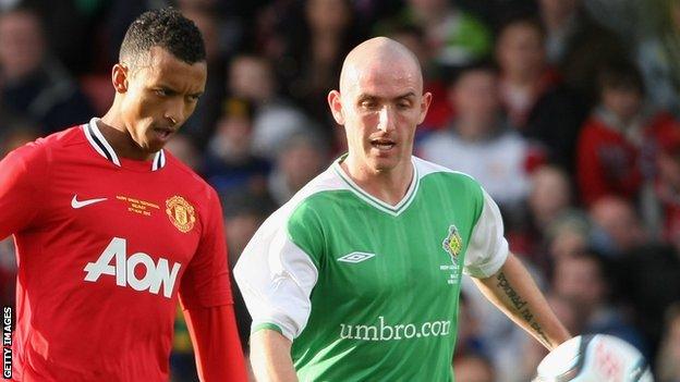 Barry Johnston closes down Manchester Utd's Nani while playing for an Irish League XI