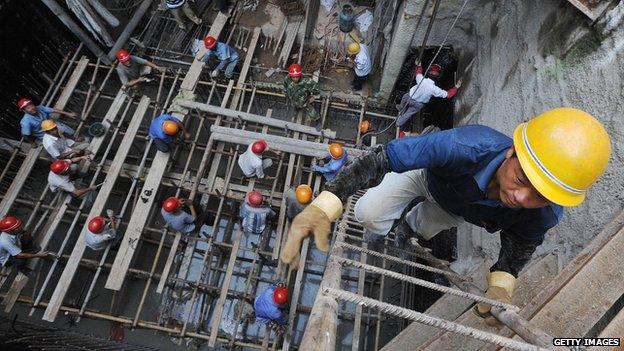 Worker climbs out of an underground construction site in Hefei, China