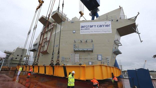 The AFT island is lowered into place on HMS Queen Elizabeth aircraft carrier at Rosyth Dockyard