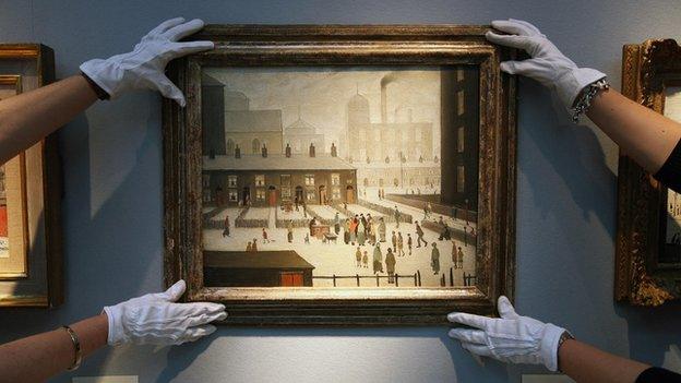 Two pairs of hands adjusting a Lowry painting