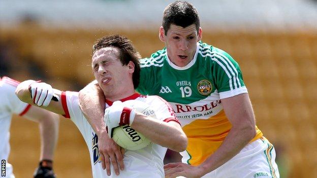 Tyrone's Colm Cavanagh is fouled by Offaly's Padraig Bracken