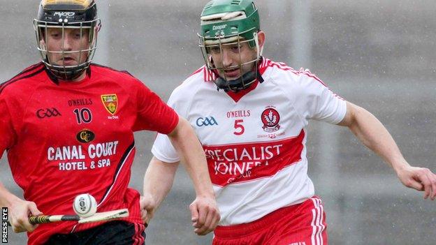 Derry's Ruairi McCloskey in action against Scott Nicholson of Down