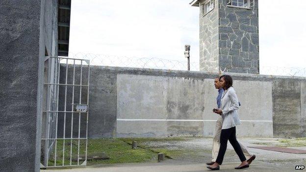 President Barack Obama and First Lady Michelle Obama in a prison yard at Robben Island, 30 June 2013