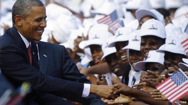 Barack Obama greets Tanzanians at an official arrival ceremony in Dar Es Salaam on 1 July 2013