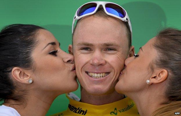 Cyclist Chris Froome being kissed by podium girls